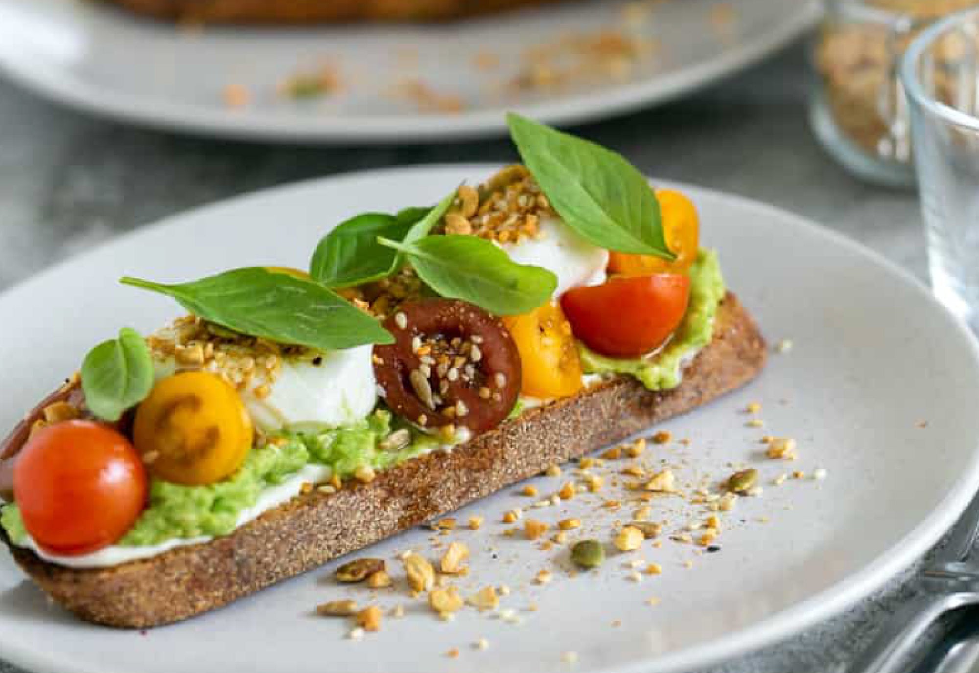 Bruschetta with bacon, avo, tomato, eggs & garlic basil pesto